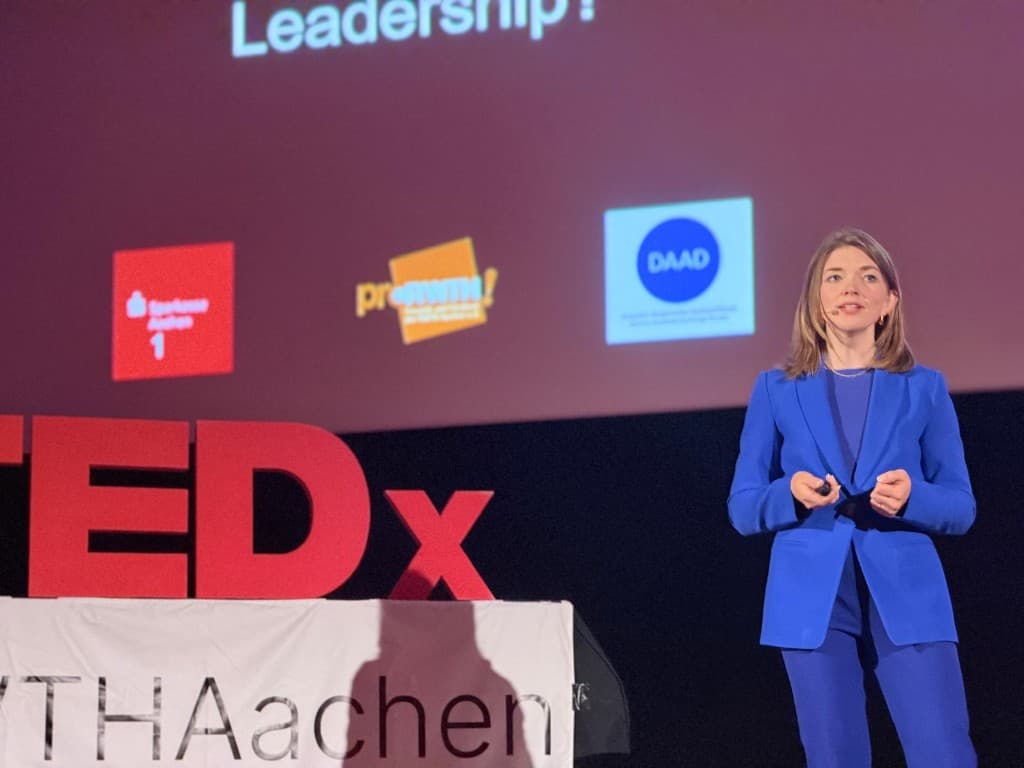 Kristina Mostovaia speaking on a TEDx stage